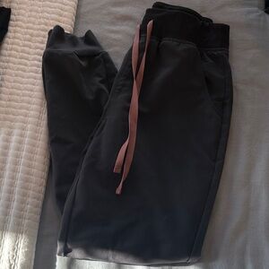 Charcoal FIGS joggers with pink drawstring + matching scrub top.